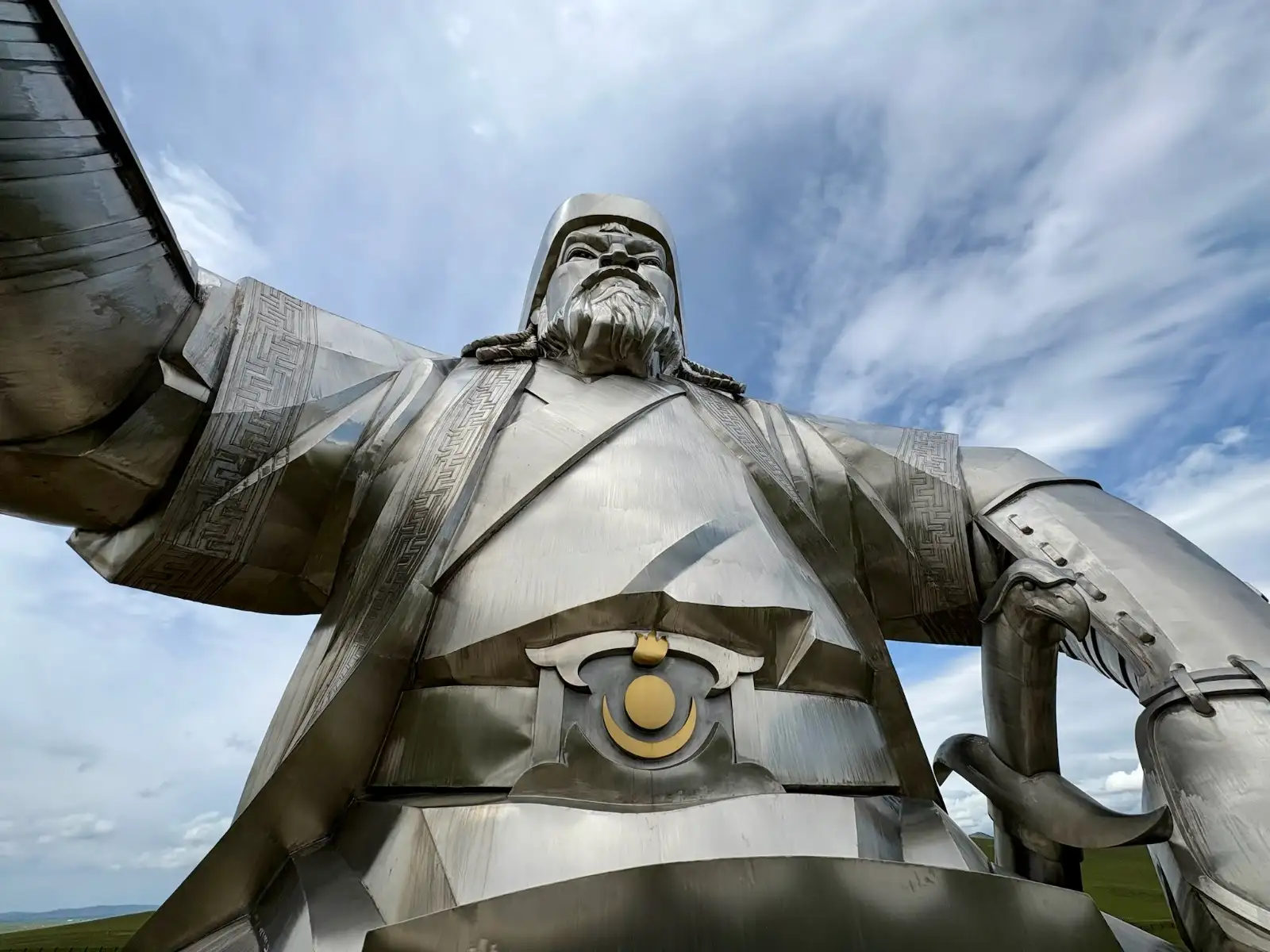 The steel Chinggis Khaan equestrian statue towering against a blue Mongolian sky